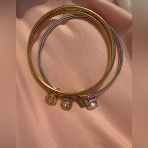 Coach 3 bangle bracelets 2 gold plated and 1 silver 
All have dangly charms